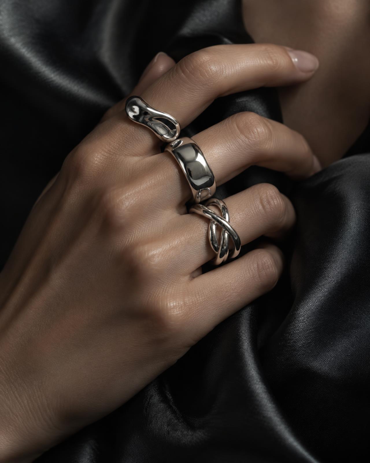 Silver rings worn against black silk